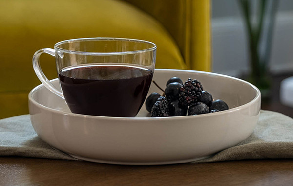 Shop Teas: cup of dark fruit tea sitting on table.