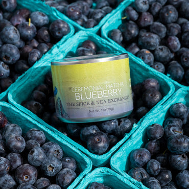 Ceremonial Matcha Blueberry container surrounded by blueberries in green cartons