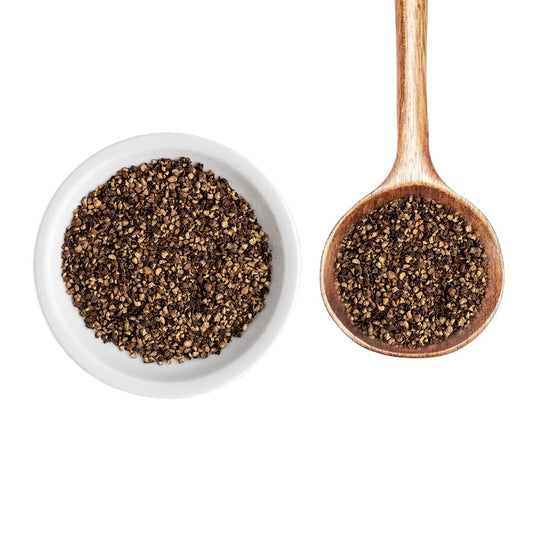 Bourbon Smoked Black Pepper in white bowl and on wood spoon