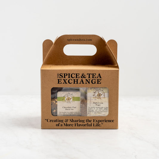 The Chocolate Lover's Gift Box is a brown cardboard box with a handle, labeled The Spice & Tea Exchange, containing Chocolate Chai tea and Dark Cocoa sugar—perfect cocoa blends. Features the slogan: Creating & Sharing the Experience of A More Flavorful Life.