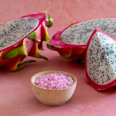 Dragon Fruit Sugar in bowl next to dragon fruit slices