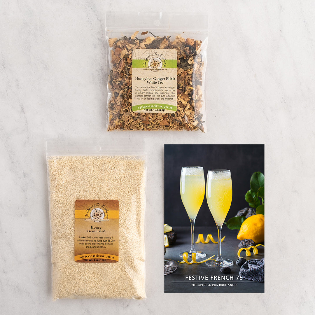 Two packaged tea products and a printed recipe card arranged on a light marble surface.