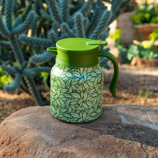 Green Hot Tea Steeper on rock with cactus in background