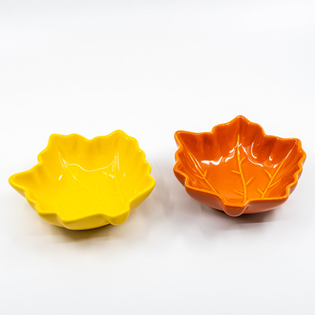 Two leaf-shaped bowls, one yellow and one orange, on a white background
