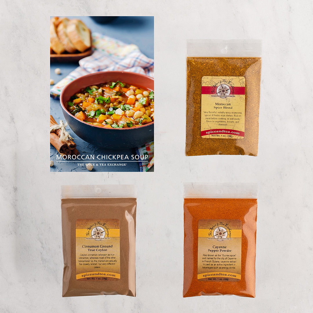 Three spice blends arranged on a light marble background, alongside a recipe card for Moroccan Chickpea Soup.