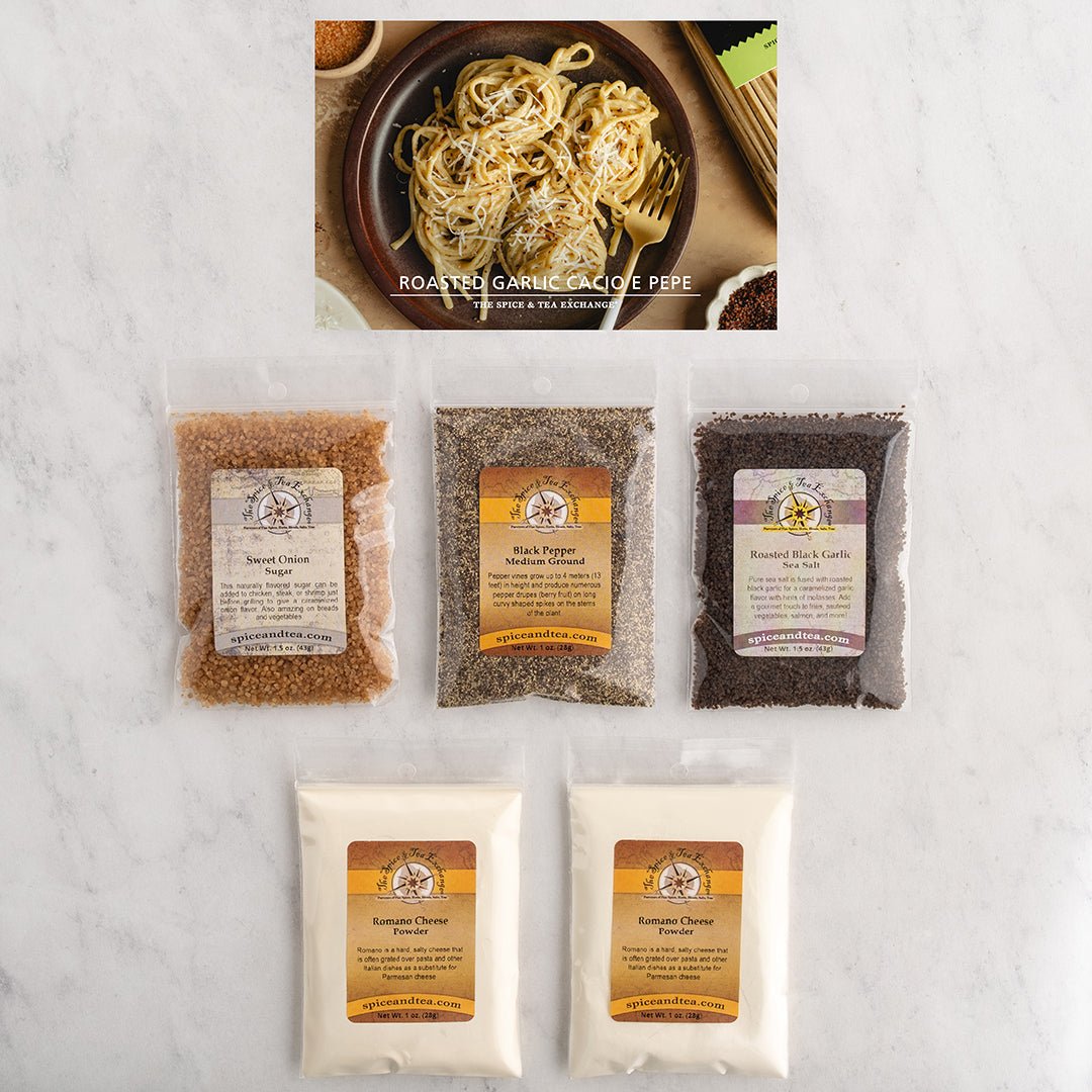 Five bags of gourmet spices and seasonings arranged on a white marble surface, with a top inset photo showing roasted garlic pasta.