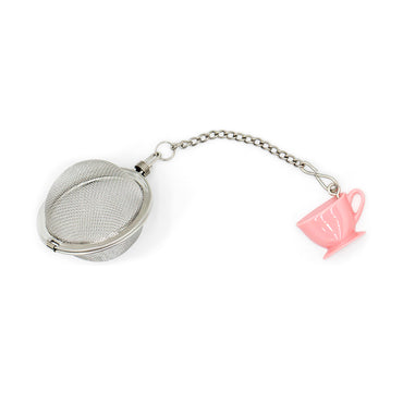 Metallic tea ball with a pink teacup charm on a white background
