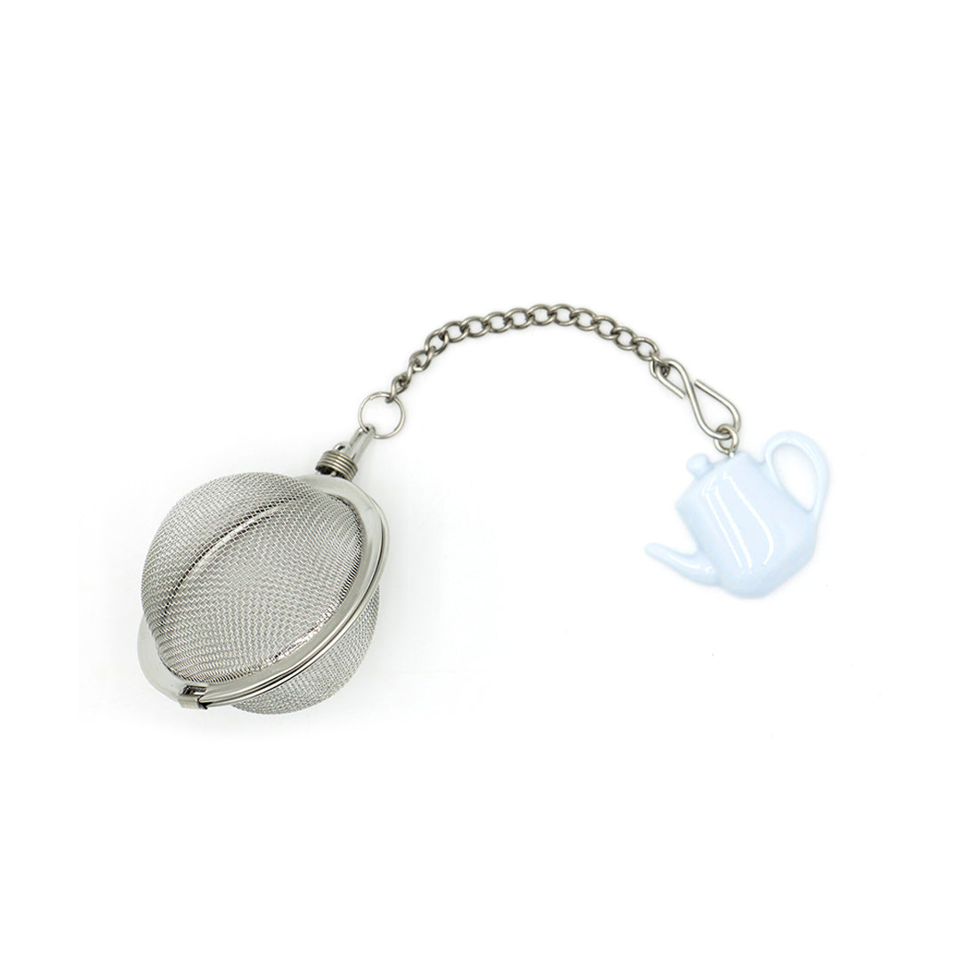 Metallic tea ball with a chain on a white background