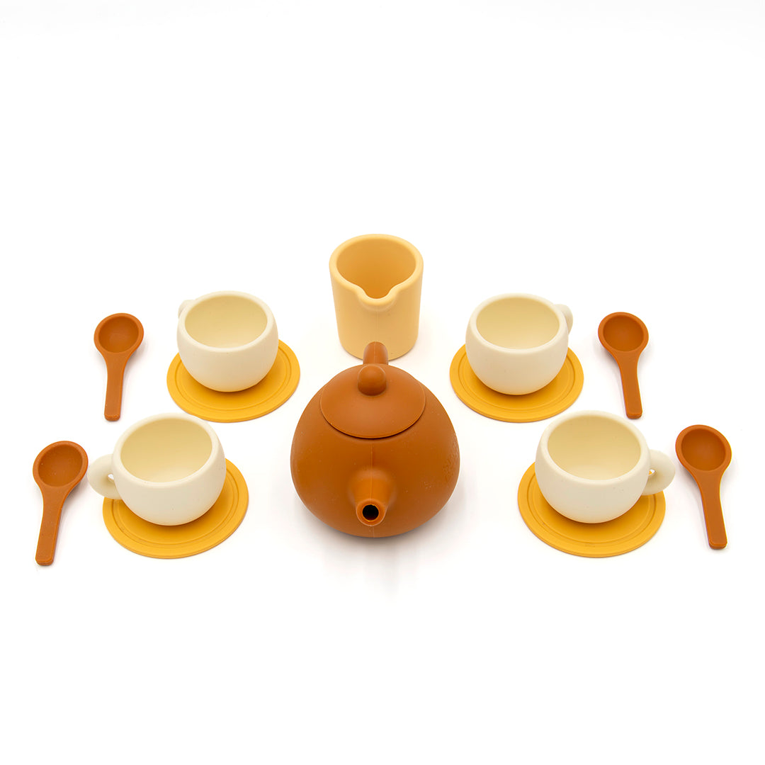 The Tiny Tea Party Toy Set includes a brown teapot, four cream cups with yellow saucers, a matching creamer, and four brown spoons—ideal for imaginative play and beautifully displayed on a white background.