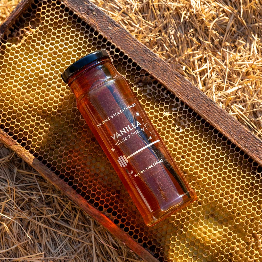 Vanilla infused honey bottle on a honeycomb background