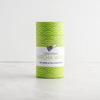 A cylindrical tin of Ceremonial Matcha Whisk spice and tea, featuring a green and white wave pattern with a white label in the center.