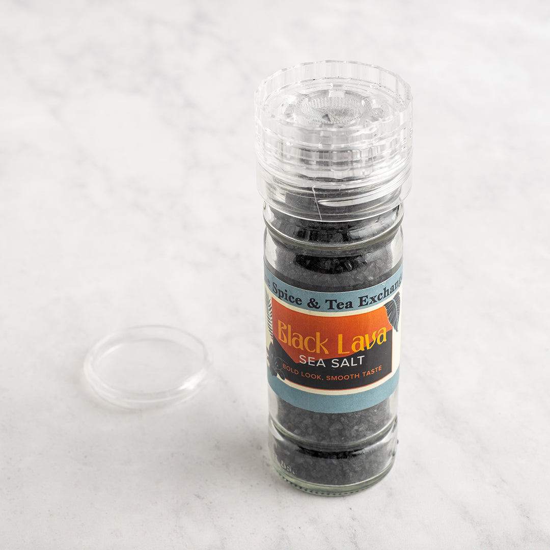 Grinder bottle of Black Lava sea salt on a white background