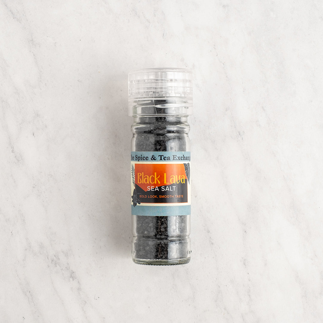 Grinder of Black Lava sea salt on a light gray background