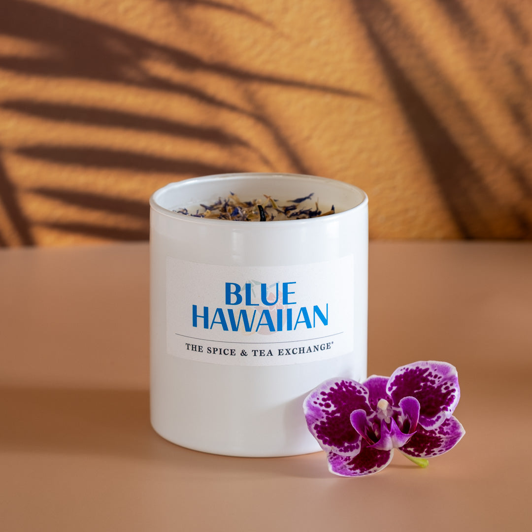 Blue Hawaiian Candle next to tropical flower