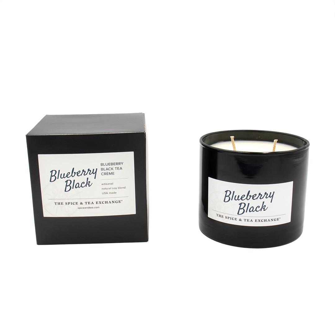 Black candle with 'Blueberry Black' label and matching black box on a white background