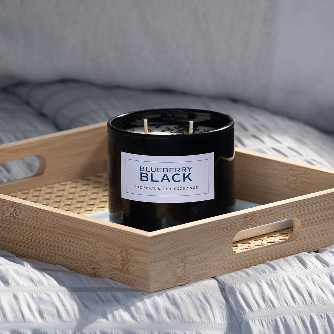 Blueberry Black Candle on tray on bed