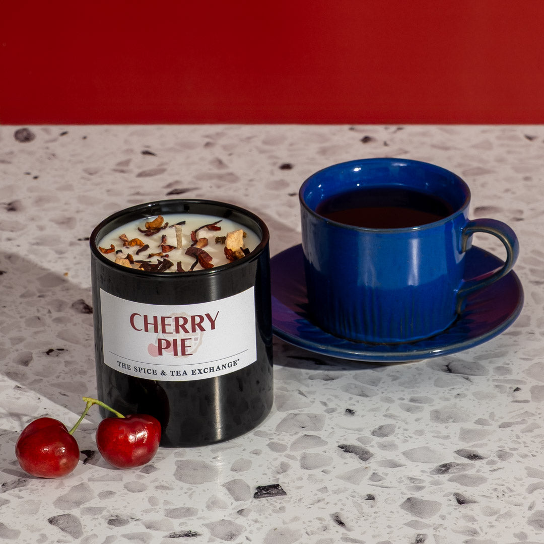 Cherry Pie Herbal Tea in blue mug next to piece of cherry pie