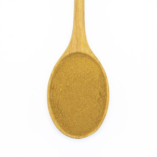 A wooden spoon filled with ground cinnamon spice.