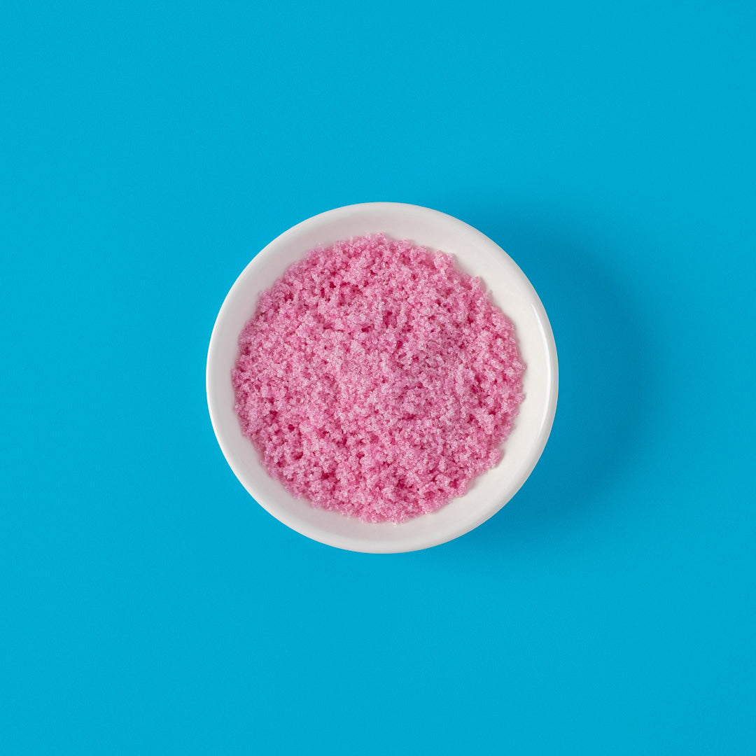 Dragon Fruit Sugar in bowl on bright blue background
