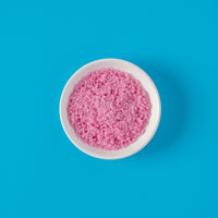Dragon Fruit Sugar in bowl on bright blue background