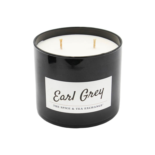 The Earl Grey Candle features a black jar with a white wax interior and three unlit wicks. Infused with essential oils, this natural soy candle from The Spice & Tea Exchange is shown on a white background.