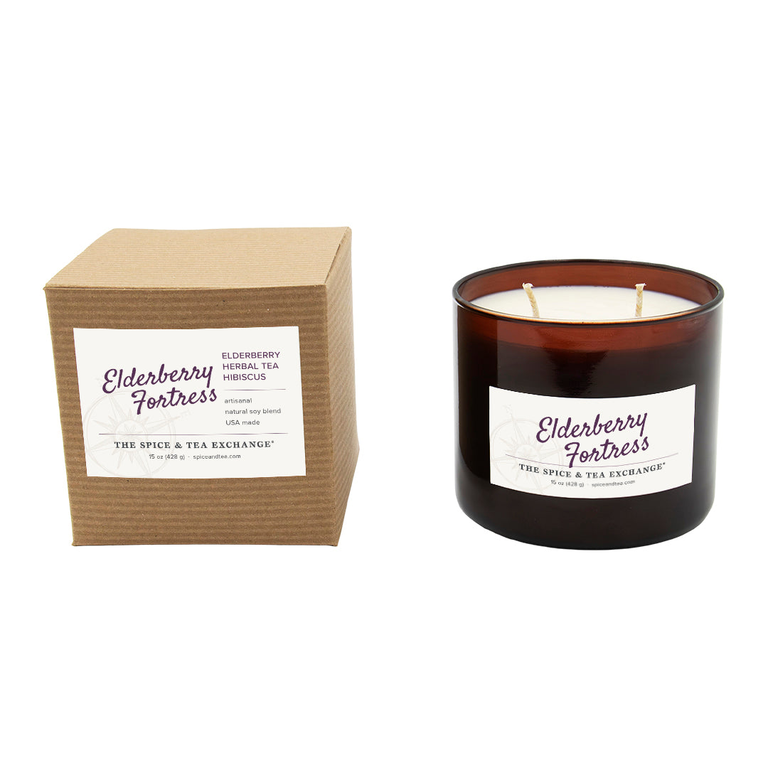 Candle and packaging with 'Elderberry Fortress' label on a white background
