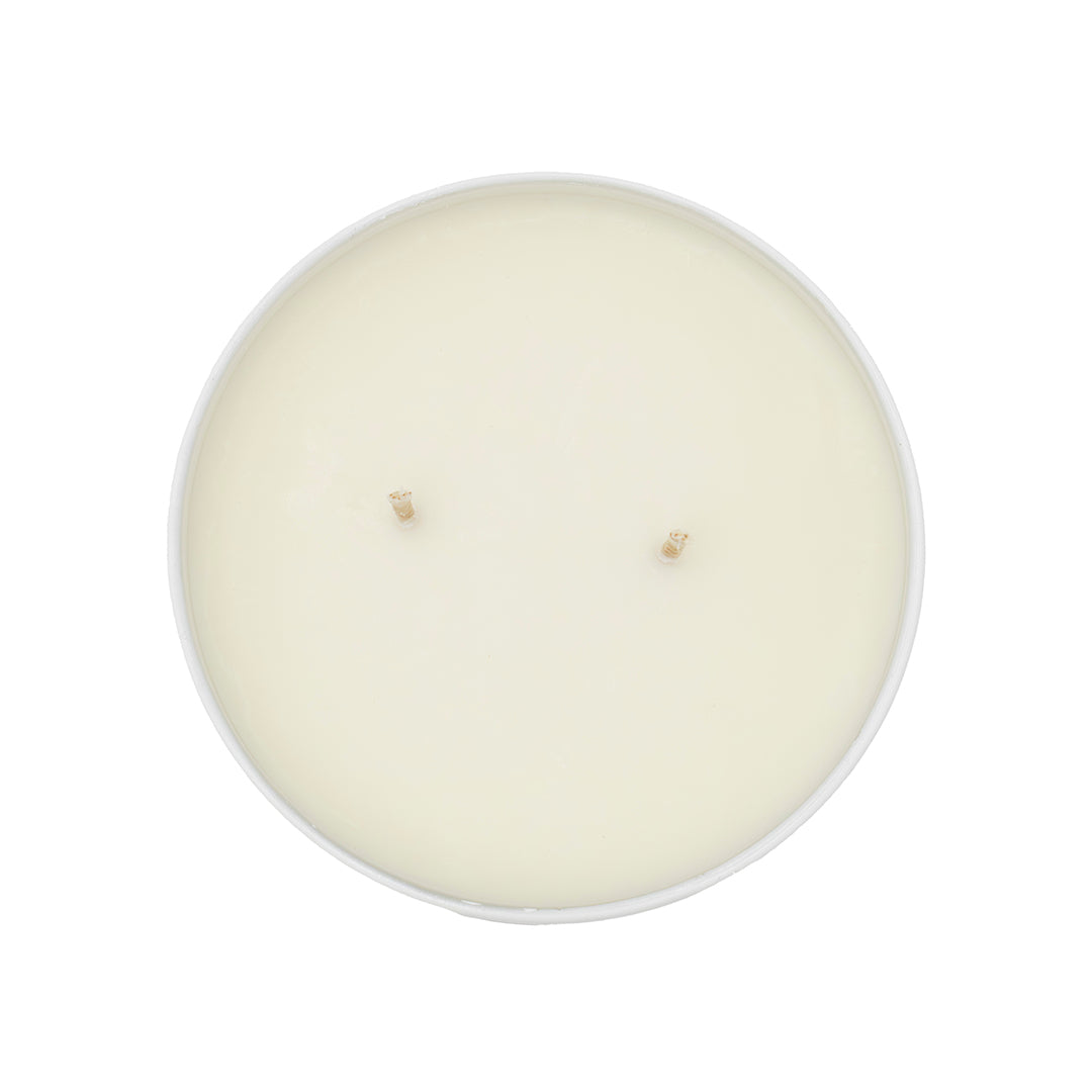 Top view of a white, unused Florida Sunshine Candle in a round container with two centered wicks, offering a fresh citrusy scent inspired by the Florida Sunshine Spice Blend.