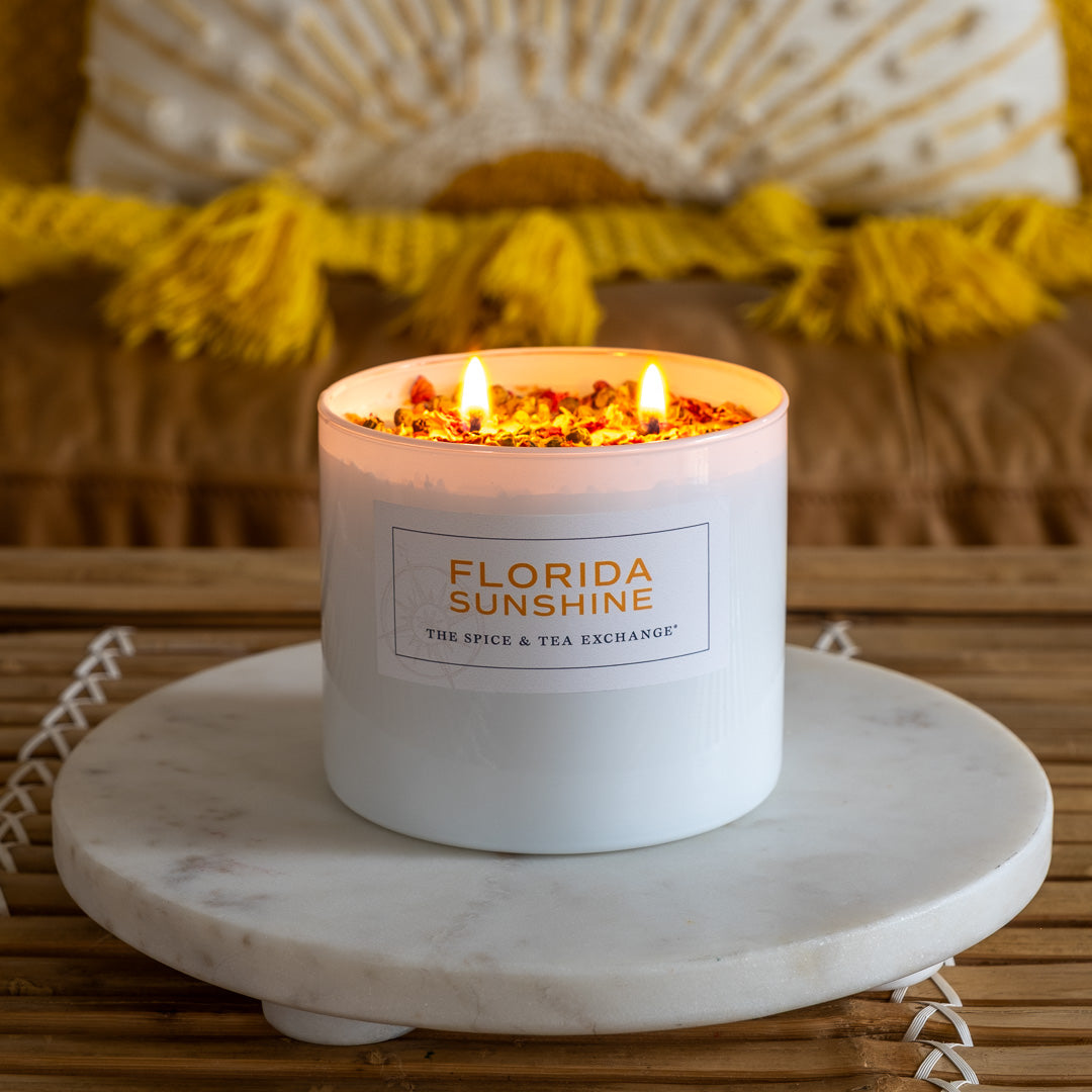 Florida Sunshine Candle lit on white tray with yellow and brown background