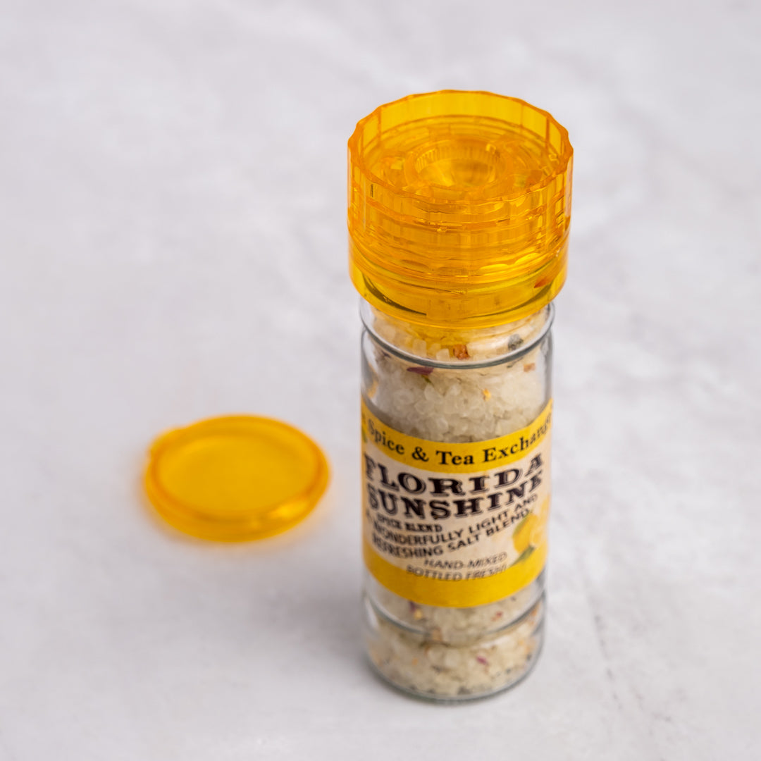 Florida Sunshine Salt Spice Blend in grinder next to lid
