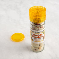 Florida Sunshine Salt Spice Blend in grinder next to lid
