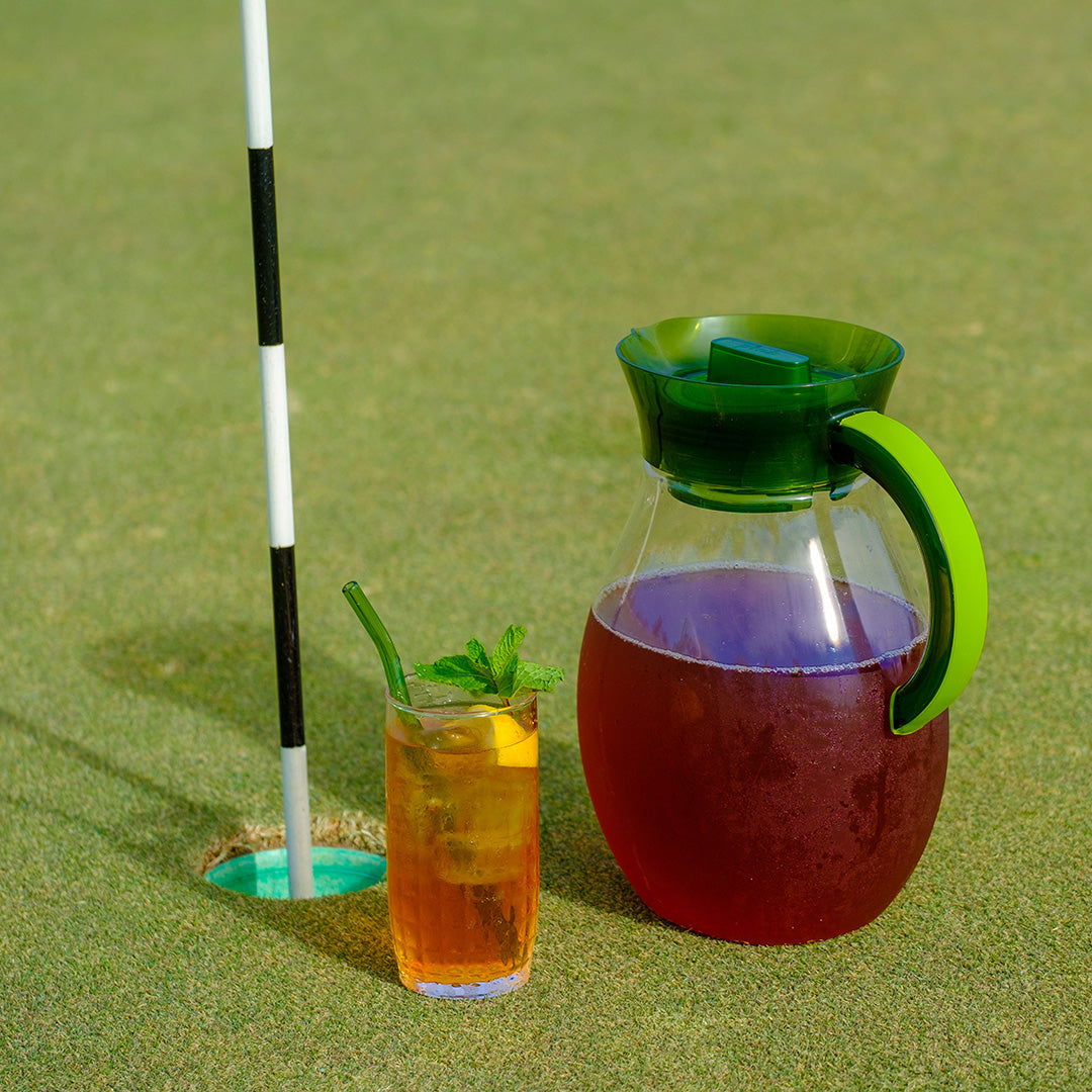 Gallon tea pitcher with iced tea on golf turf