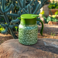 Green Hot Tea Steeper on rock with cactus in background