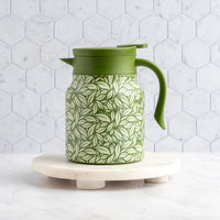 Green Hot Tea Steeper in front of tile background