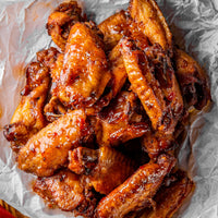 Baked chicken wings on crumpled parchment paper