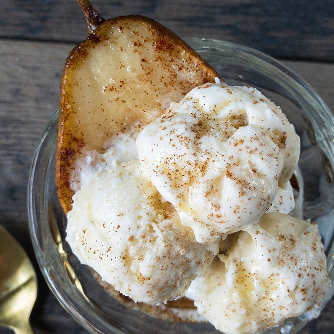 Ice cream with a pear slice on a wooden surface