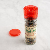 Spice jar with red lid and 'Italian Street Fire' label on a light gray background next to red lid