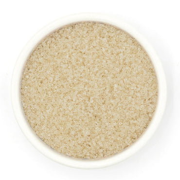 Close-up of a bowl filled with Lavender Sugar on a white background
