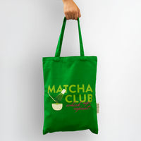 Green tote bag with 'Matcha Club' text and design on a white background