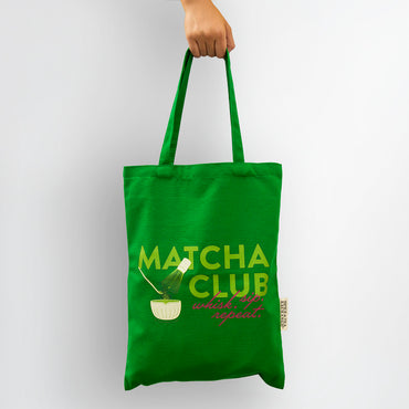 Green tote bag with 'Matcha Club' text and design on a white background