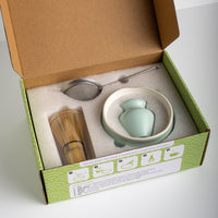 Tea-making set with a: Matcha Bowl (ceramic), Matcha Whisk (bamboo), Whisk Holder (ceramic), Matcha Sieve (stainless steel), Matcha Scoop (bamboo) in a box on a white background