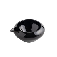 Black ceramic bowl on a white background