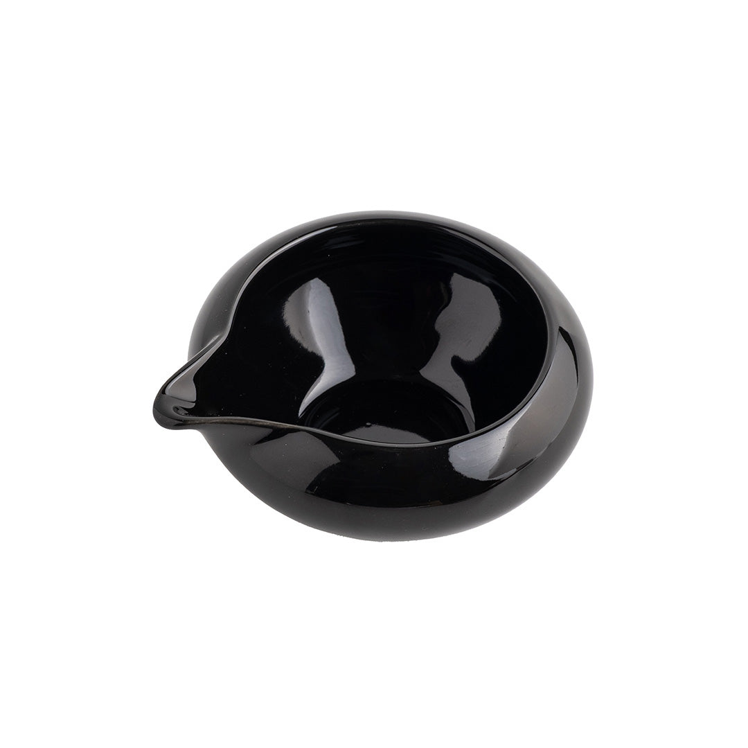 Black ceramic pitcher on a white background