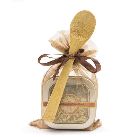 The Onion Obsession Spice Blend - Spice Tin with Spoon comes in a sheer brown gift bag tied with a brown ribbon and features a wooden spoon—an ideal gift for any true onion lover.