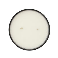 Round candle with a black lid on a white background
