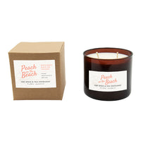 Candle with packaging labeled 'Peach on the Beach' by The Spice & Tea Exchange on a white background.
