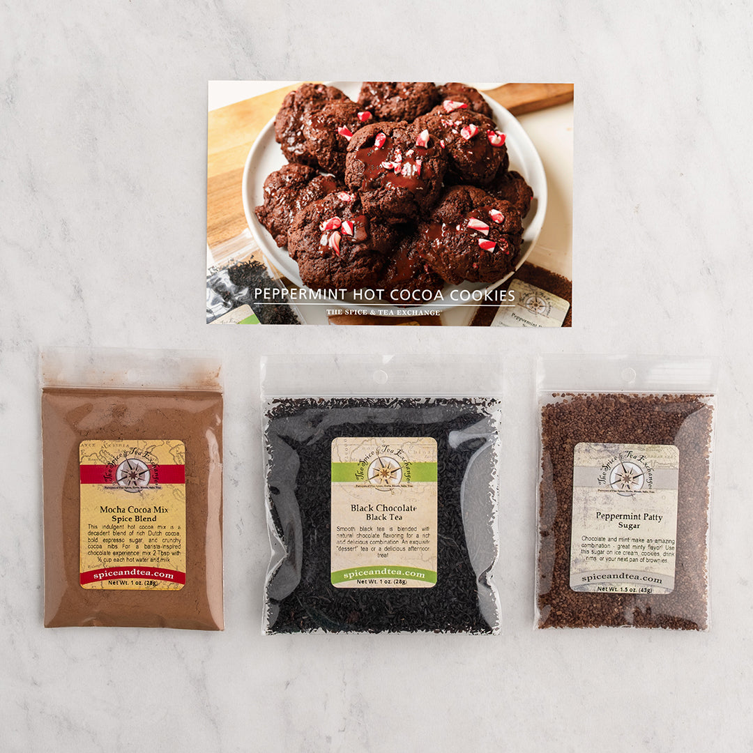 A flat-lay product shot of a Peppermint Hot Cocoa Cookies recipe kit on a white marble background.