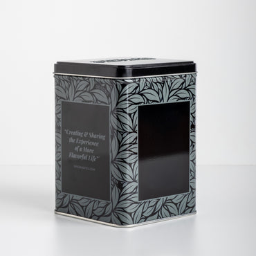 Decorative black grey and silver tea tin with leaf pattern on a white background. With text: Creating & Sharing the Experience of a More Flavorful Life SPICEANDTEA.com