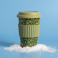 Reusable Hot Cup 12 oz - Tea Leaf Green on blue background in pile of snow