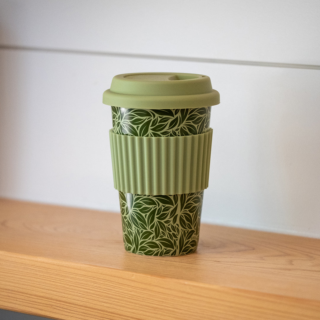 Reusable Hot Cup 12 oz - Tea Leaf Green on wood countertop