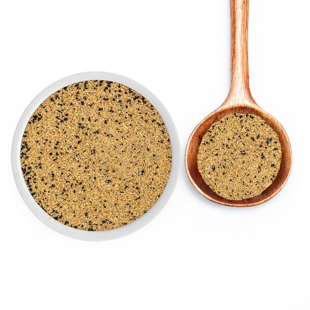 Roasted Espresso Monk Fruit Sweetener in a white bowl and wooden spoon